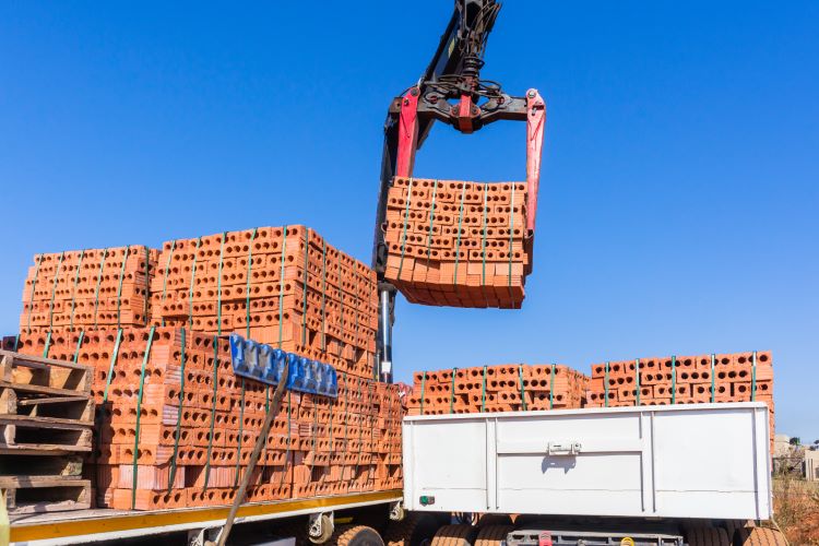 Crane Lifting Bricks